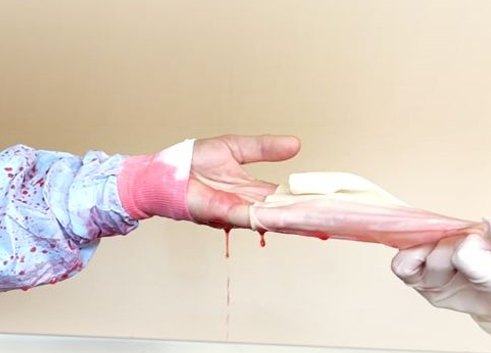 Demonstration of synthetic fluid wicking through the cuff of a standard surgical gown